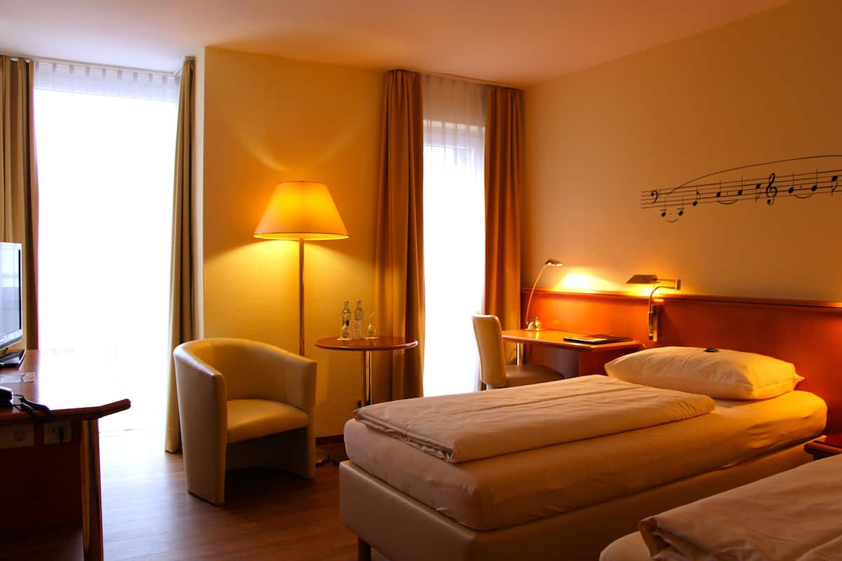 hypo-allergenic bedding, desk, laptop workspace, blackout curtains