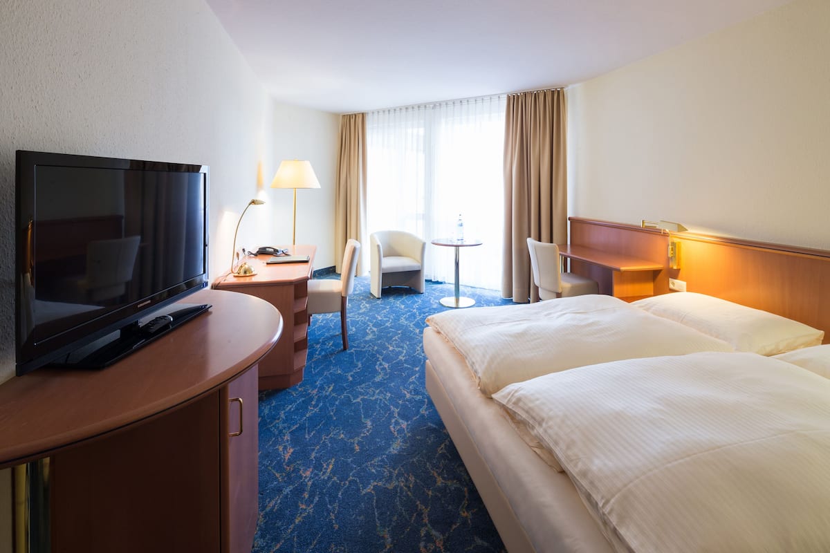 Hypo-allergenic bedding, desk, laptop workspace, blackout drapes