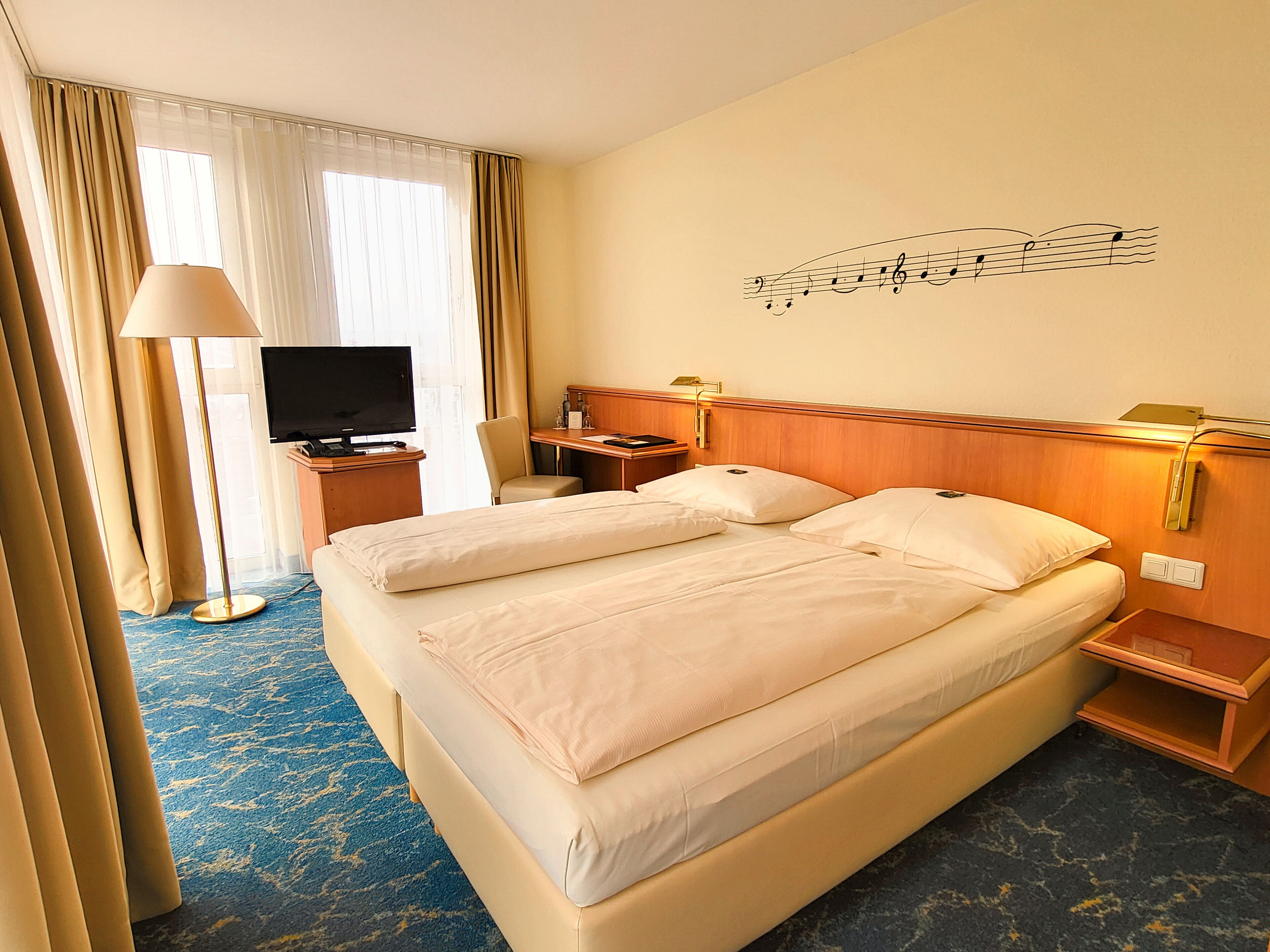 hypo-allergenic bedding, desk, laptop workspace, blackout curtains