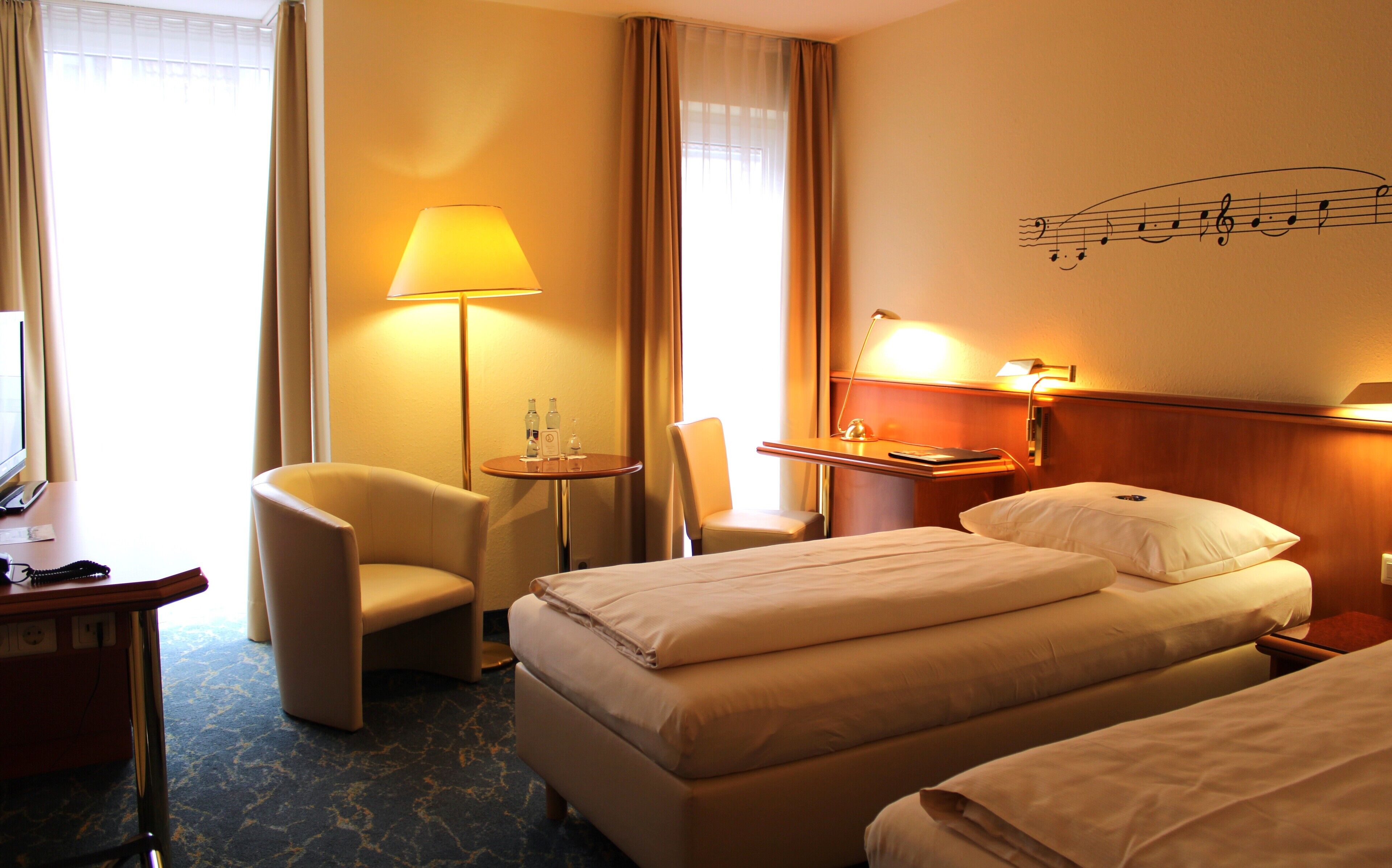 hypo-allergenic bedding, desk, laptop workspace, blackout curtains