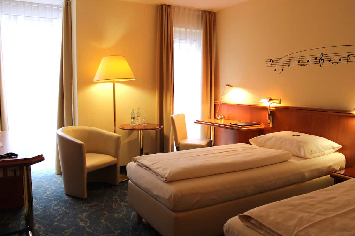 hypo-allergenic bedding, desk, laptop workspace, blackout curtains