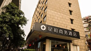 A tall building with a sign for a hotel.