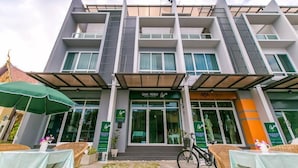 A modern building with a green sign reading "Lyte Monkey." - White Monkey Guesthouse (Phetchaburi)
