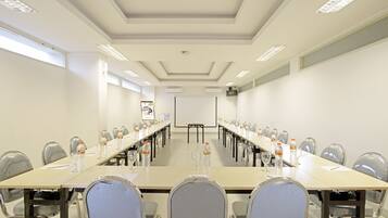 A conference room with a long table, chairs, and water bottles.