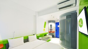 A modern hotel room with a bed, a desk, a sink, and a large window. - POP! Hotel Diponegoro Surabaya (Surabaya)