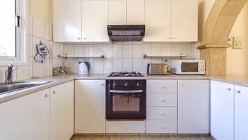 Villa, 2 Bedrooms | Private kitchen | Fridge, microwave, stovetop, coffee/tea maker