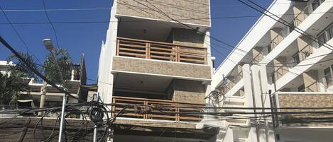 A multi-story building with a sign for Abozza Resort.