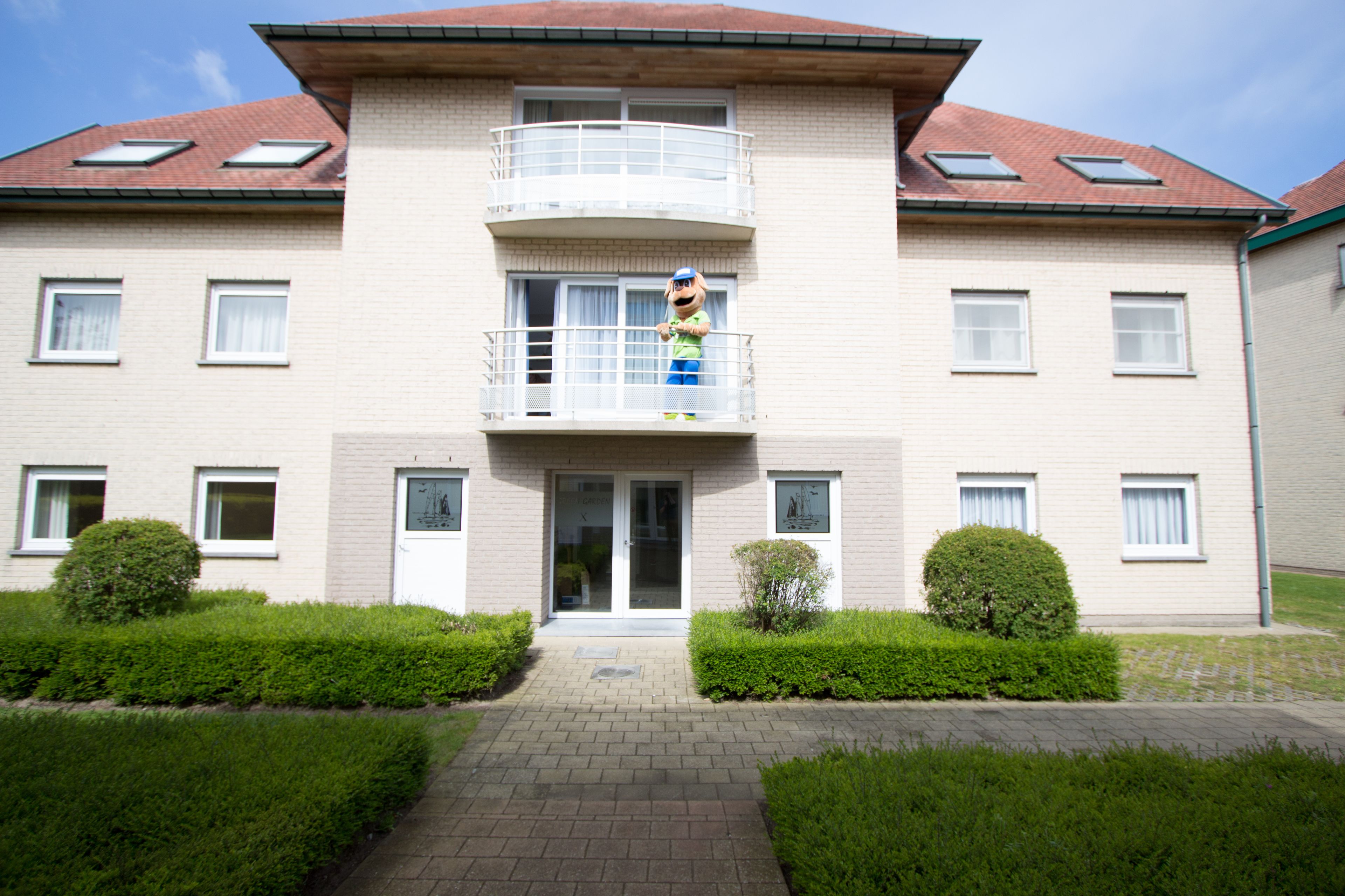 A two-story building with a balcony on the second floor.