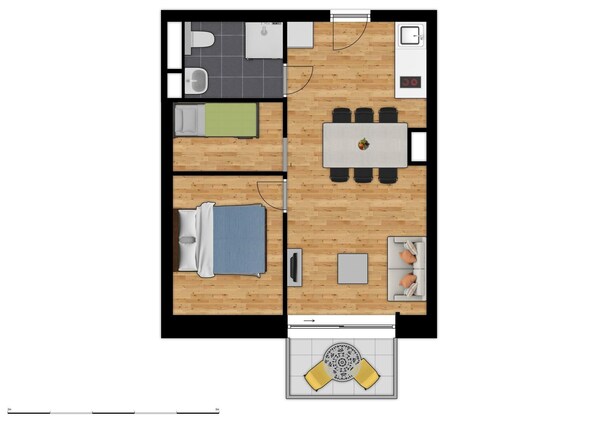 Habitación de 5 por 5 metros con cama, una mesita, sofá, mesa de comedor con sillas, lavamanos y un inodoro.
