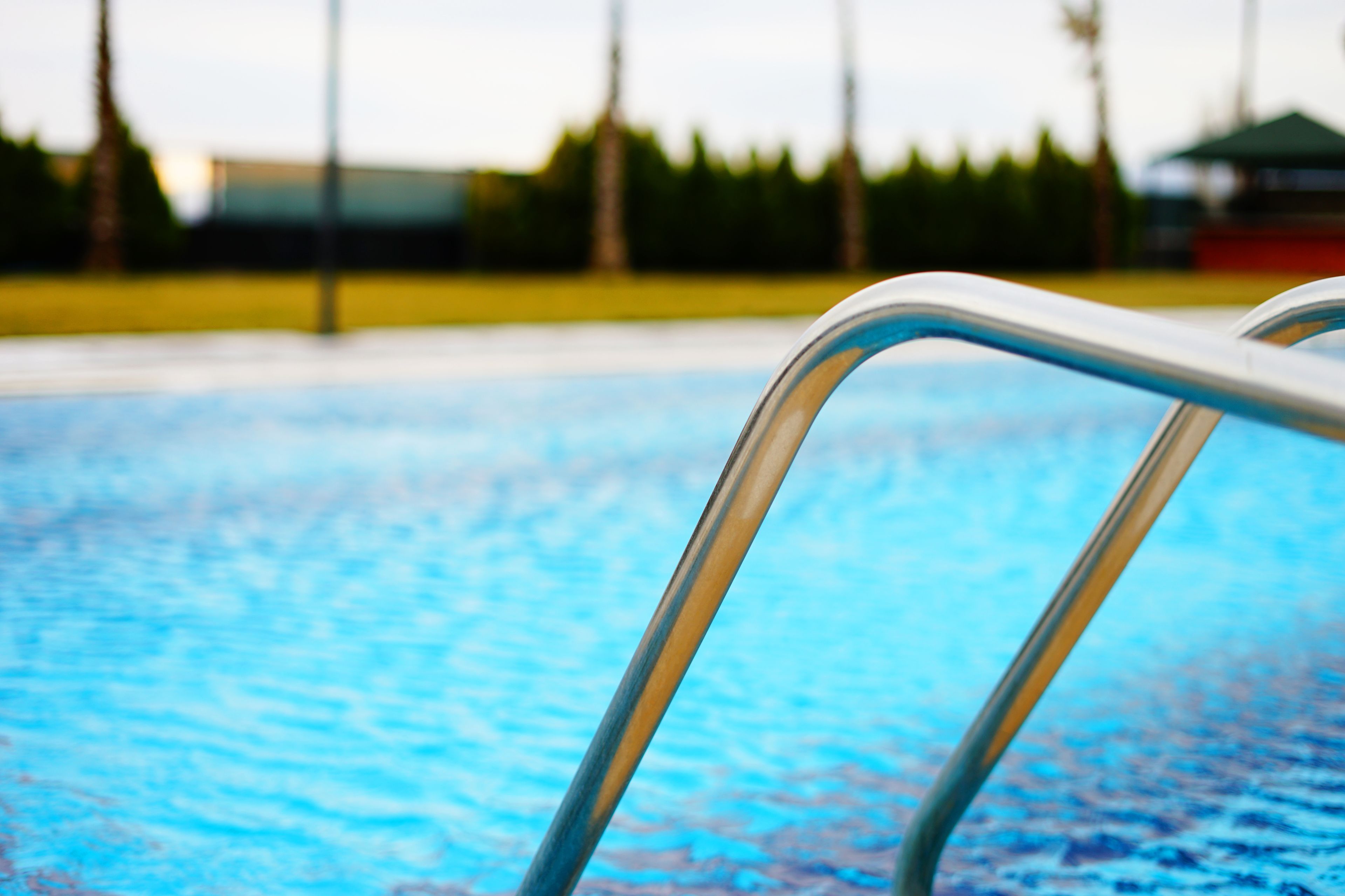 A swimming pool with a metal ladder.