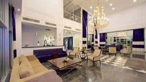 A spacious lobby with a checkered floor, a large chandelier, and a reception desk. - Ramada by Wyndham Soma (Soma)