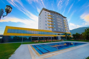 Outdoor pool, open 10:00 AM to 7:00 PM, pool umbrellas, pool loungers