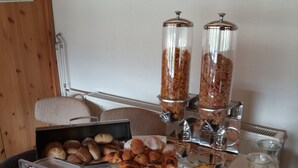 A breakfast buffet with various food items, including pastries, fruits, and beverages. - Lónkot Rural Resort (Skagafjörour)