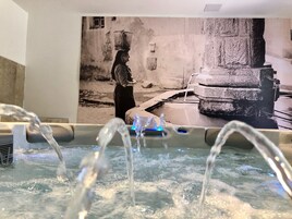 Un espacio de spa con una fuente de agua y un mural.