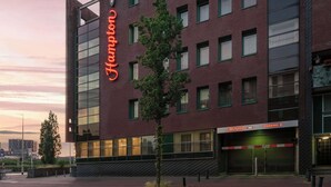 A modern hotel building with a prominent 'Hampton' sign on the facade. - Hampton by Hilton Amsterdam Centre East (Amsterdam)