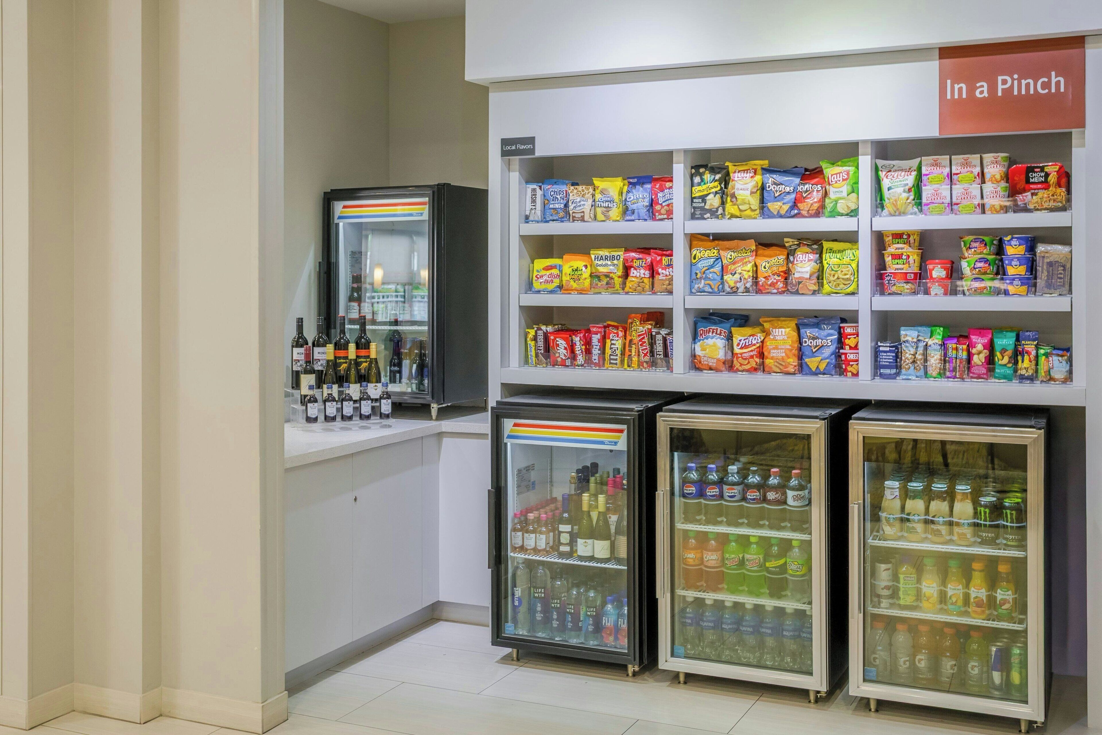 A snack and beverage section with various packaged snacks and refrigerated drinks.