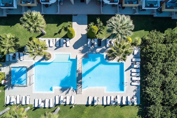Seasonal outdoor pool, open 9 AM to 7 PM, pool umbrellas, pool loungers