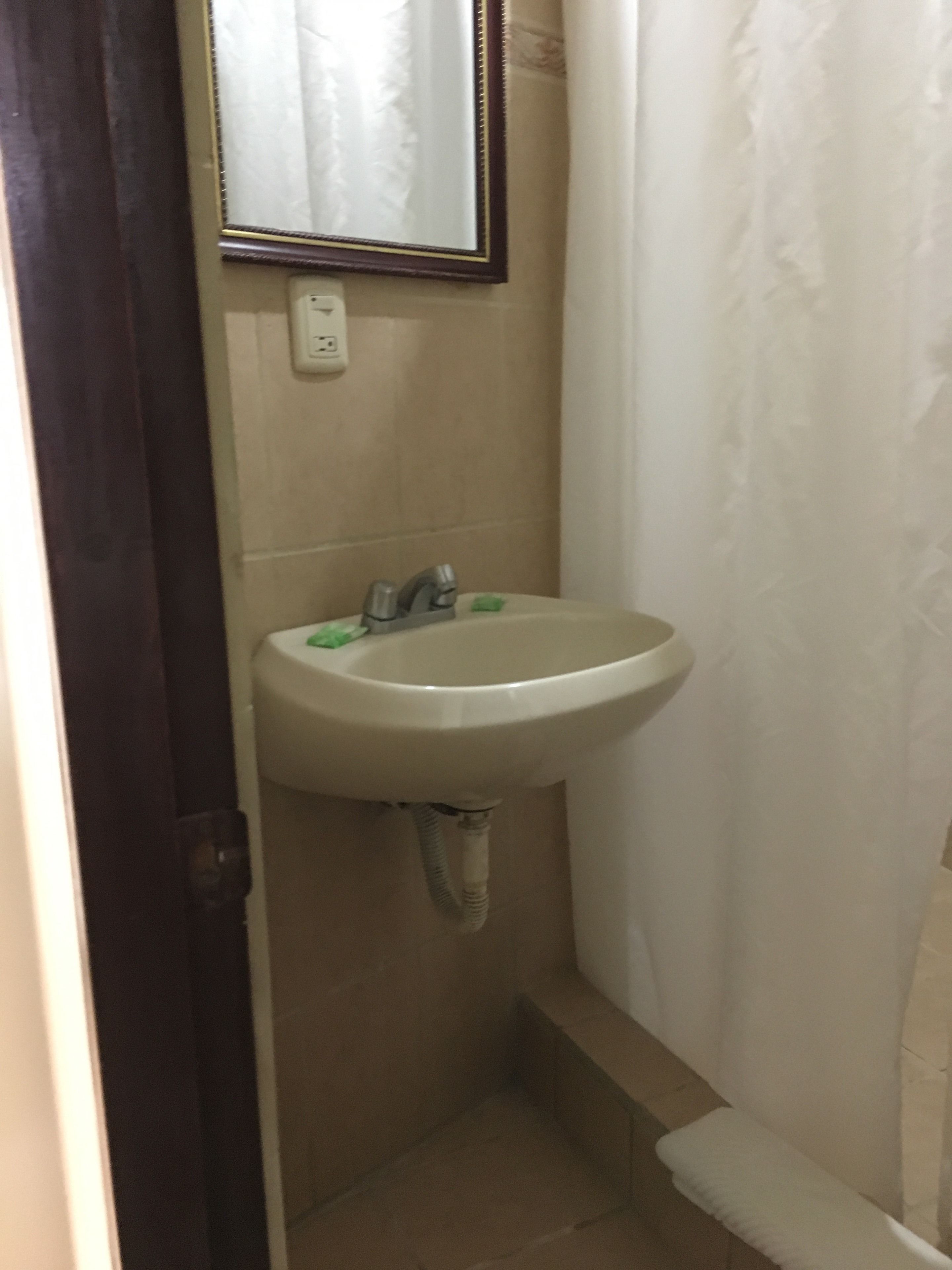 standard room, 1 double bed, refrigerator & microwave | bathroom sink