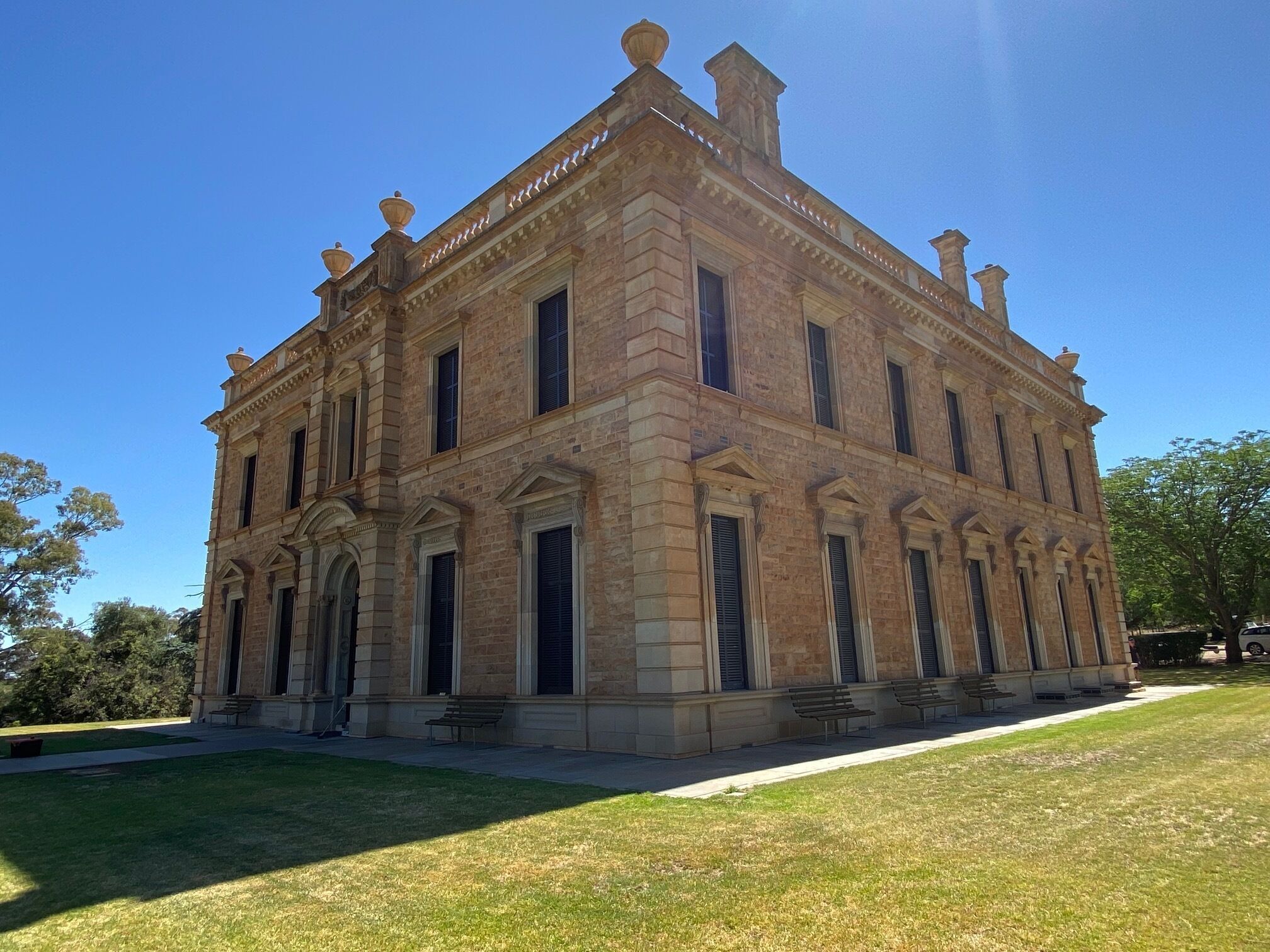 A large, historic building with a symmetrical facade, multiple windows, and a central entrance.