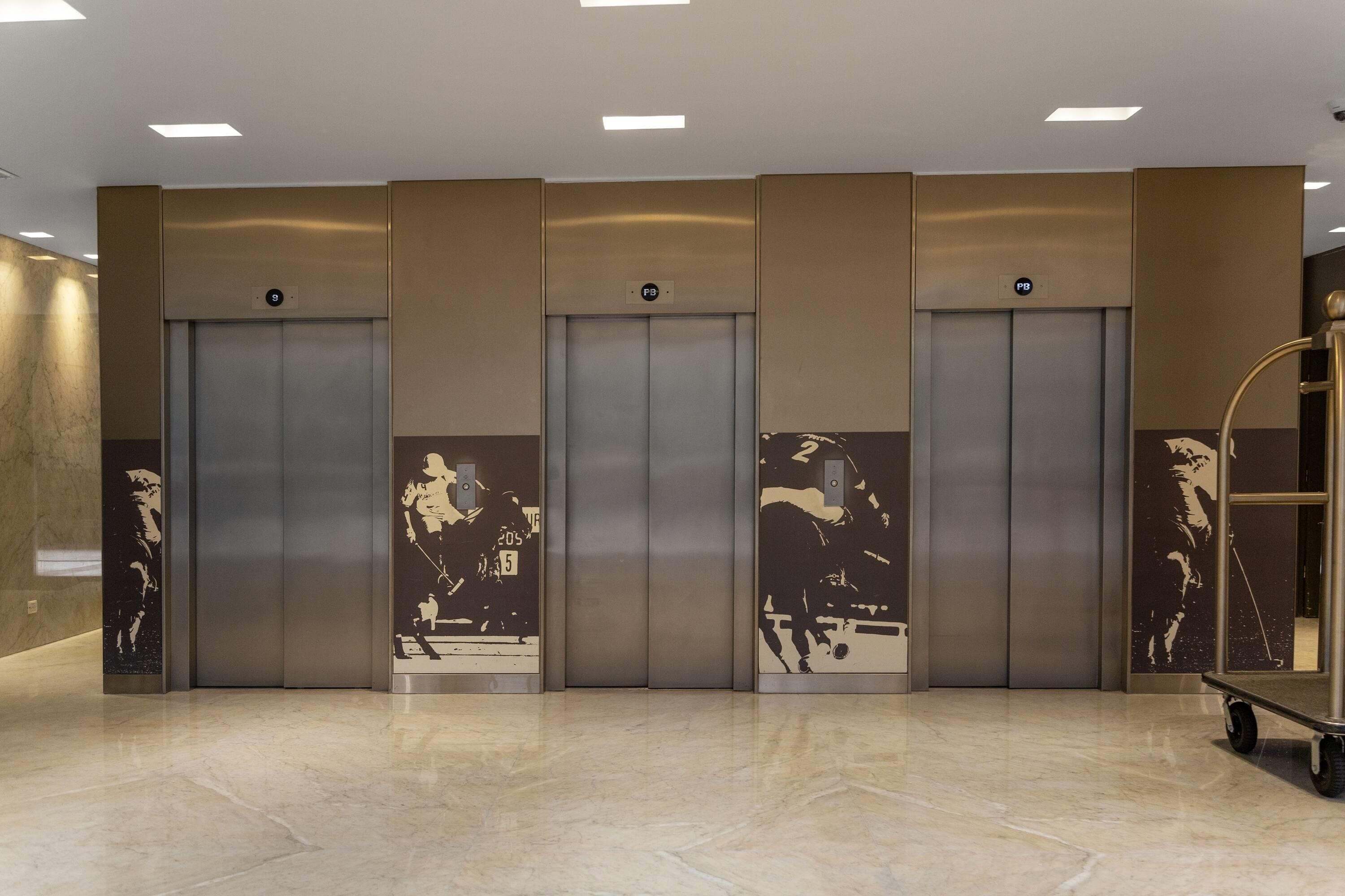 A modern elevator area with four elevators, each marked with a number.