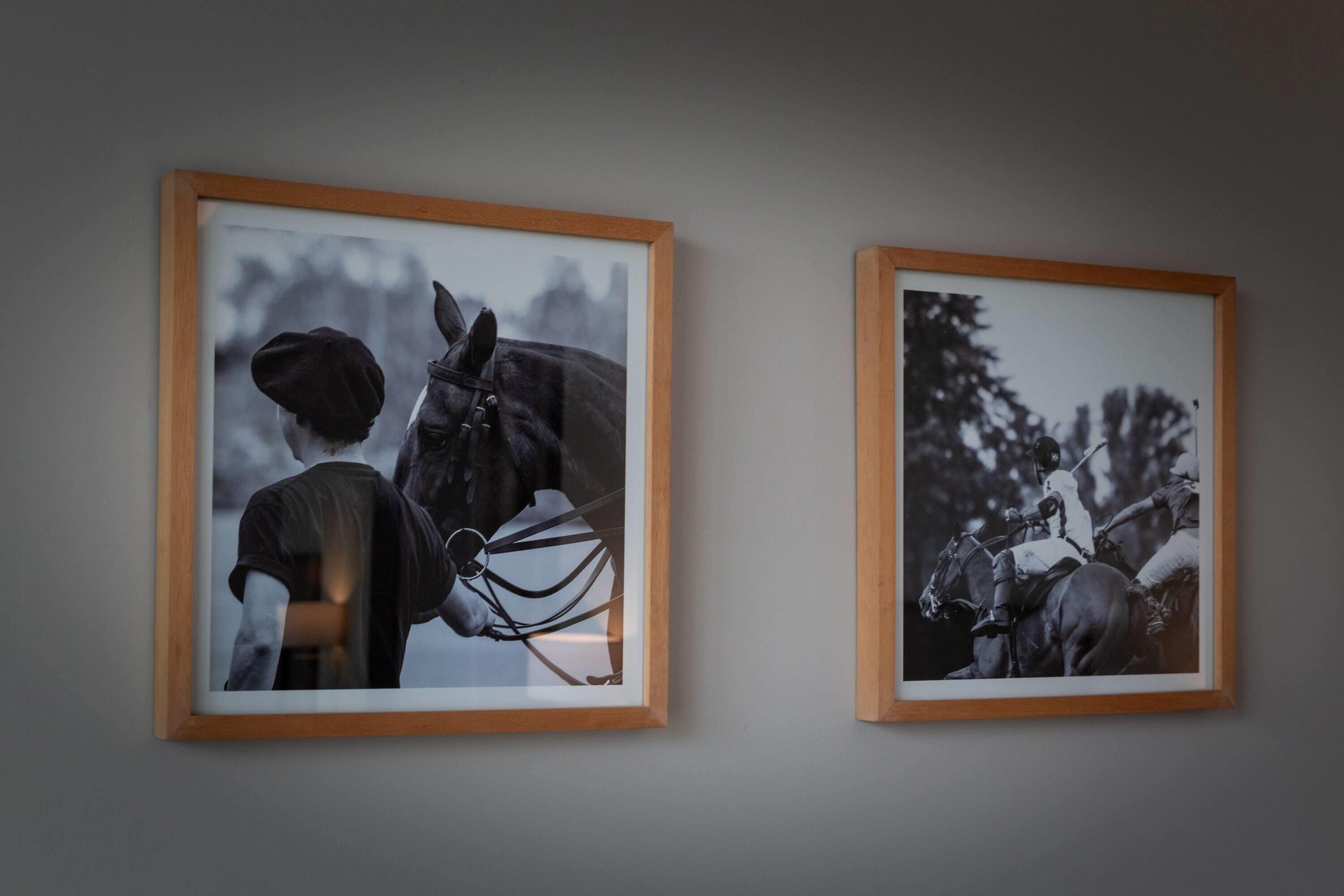 Two framed photographs of horse riders on horseback.
