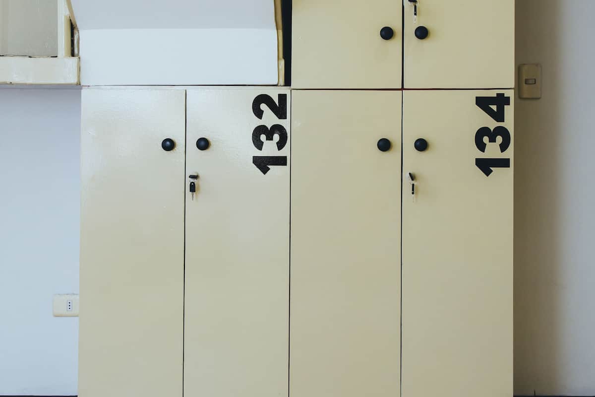 A set of beige lockers with numbers 132, 133, and 134.