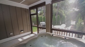A hot tub with a view of a backyard.