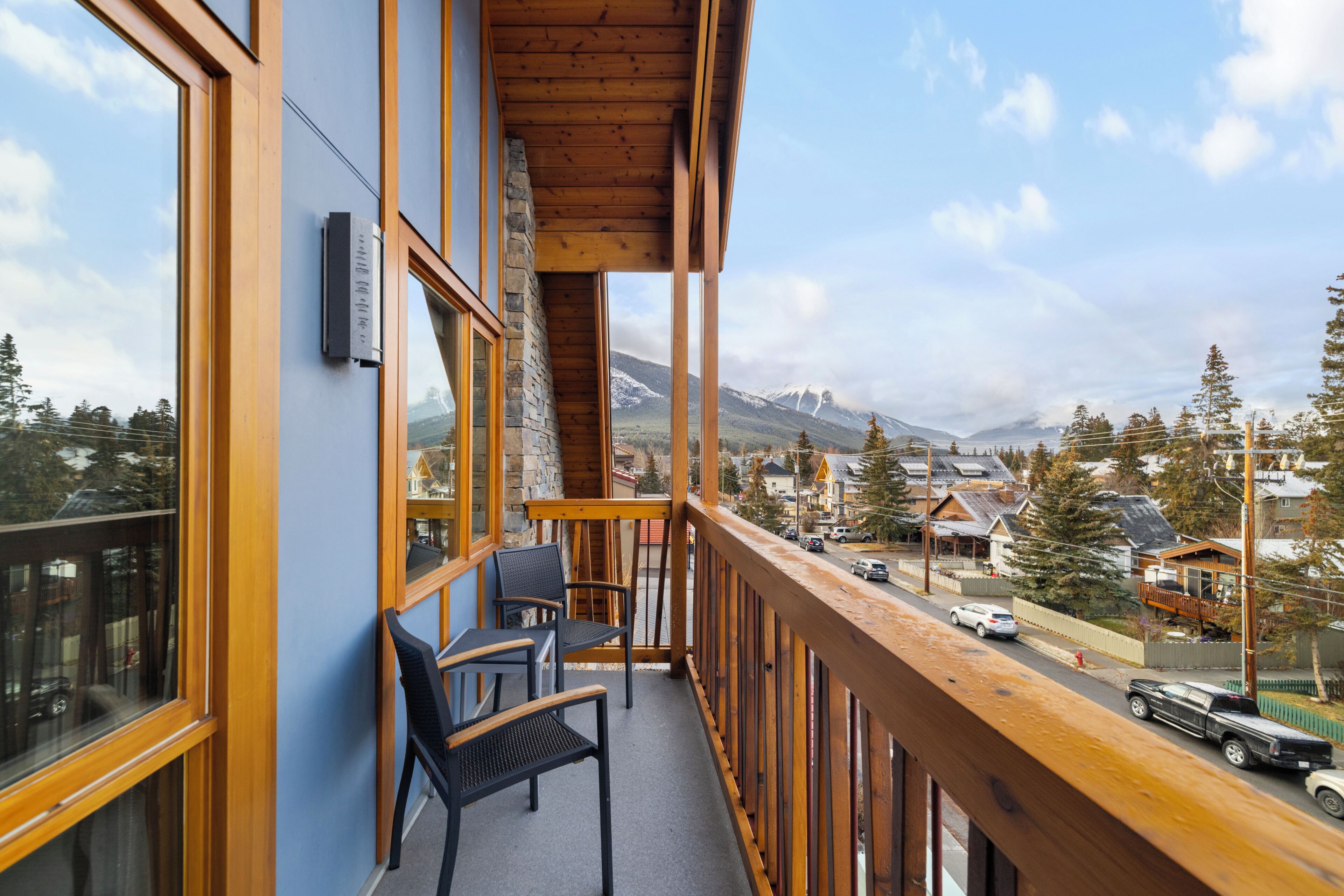 A balcony with a view of a mountain and a town.