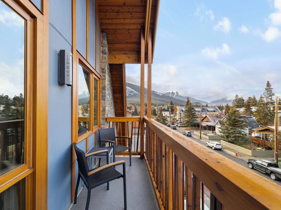 A balcony with a view of a mountain and a town.