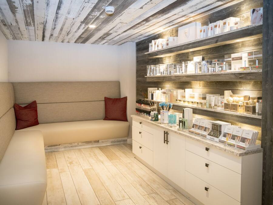 A modern kitchen with a built-in bench and shelves stocked with kitchenware.