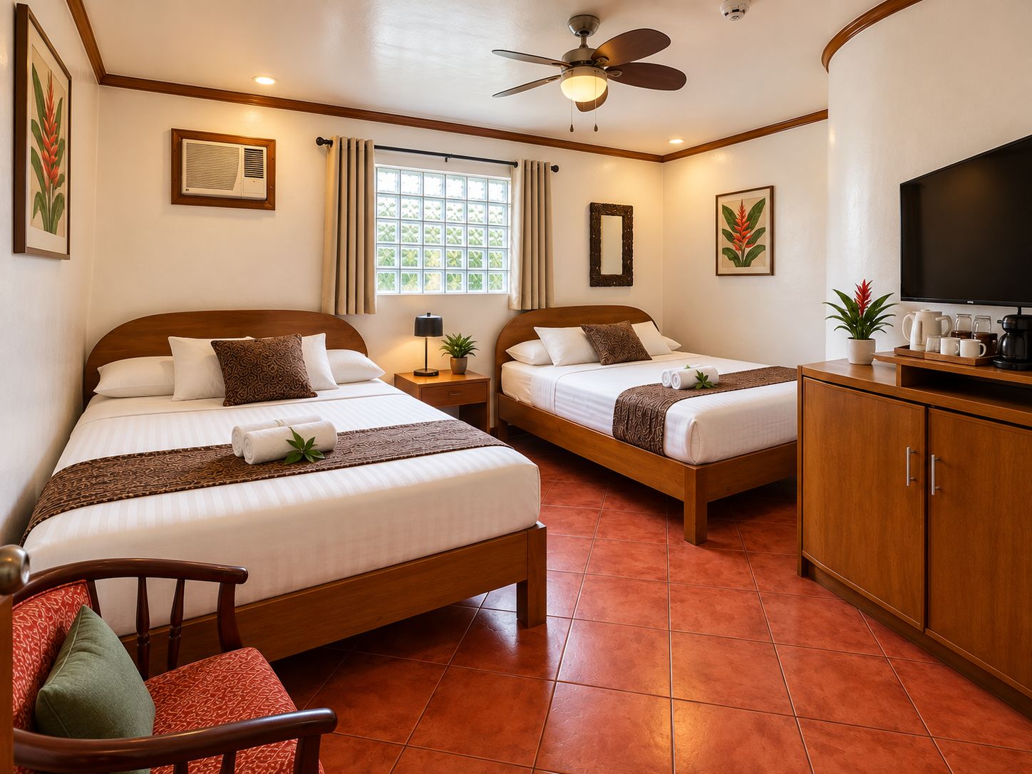A hotel room with two beds, a TV, a coffee maker, and a plant.