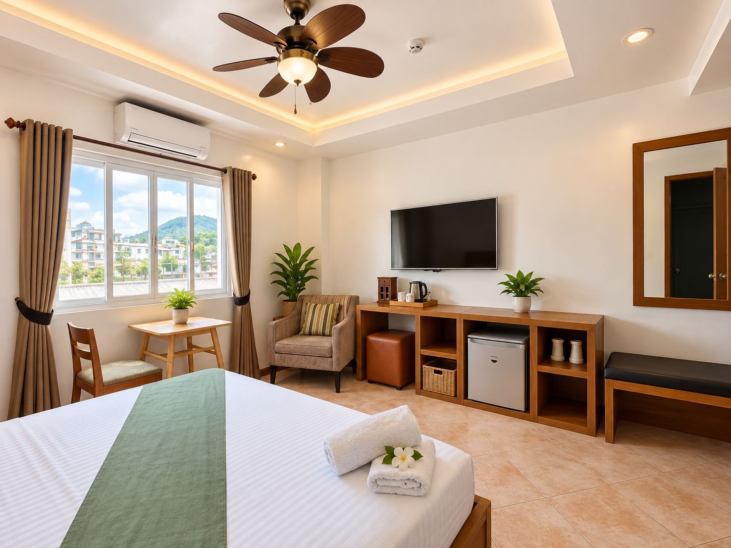 A hotel room with a bed, a desk, a chair, a television, and a ceiling fan.