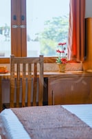 A wooden chair and a small table with a potted plant.