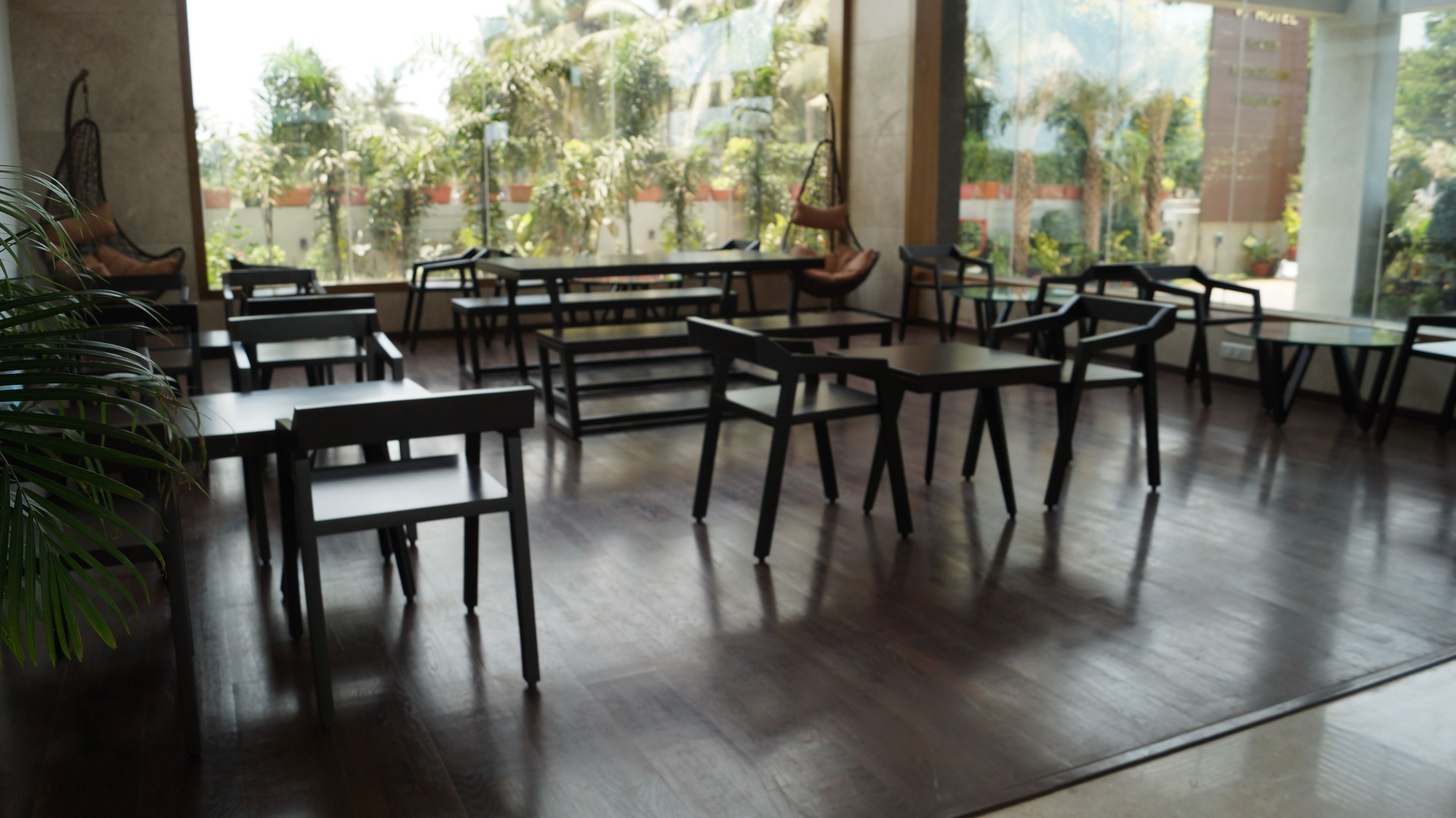 A spacious indoor area with multiple tables and chairs arranged for dining.