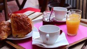A breakfast tray with croissants, a cup of coffee, a glass of orange juice, and a jar of jam. - Hotel Le Forum (Bastia)