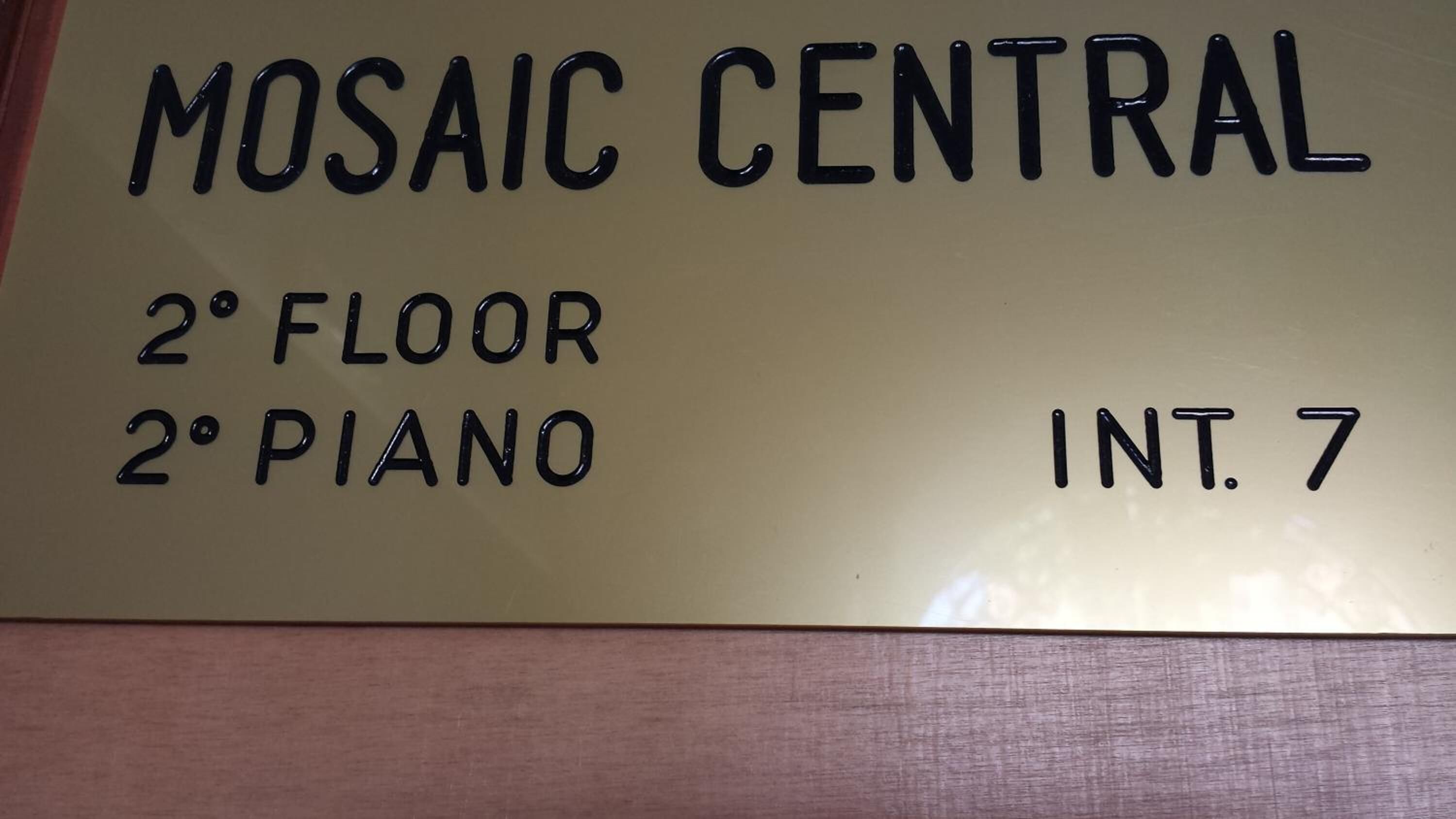 A sign indicating the location of Mosaic Central on the 2nd floor, piano, and room number 7.