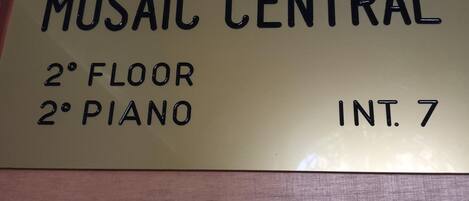 A sign indicating the location of Mosaic Central on the 2nd floor, piano, and room number 7.