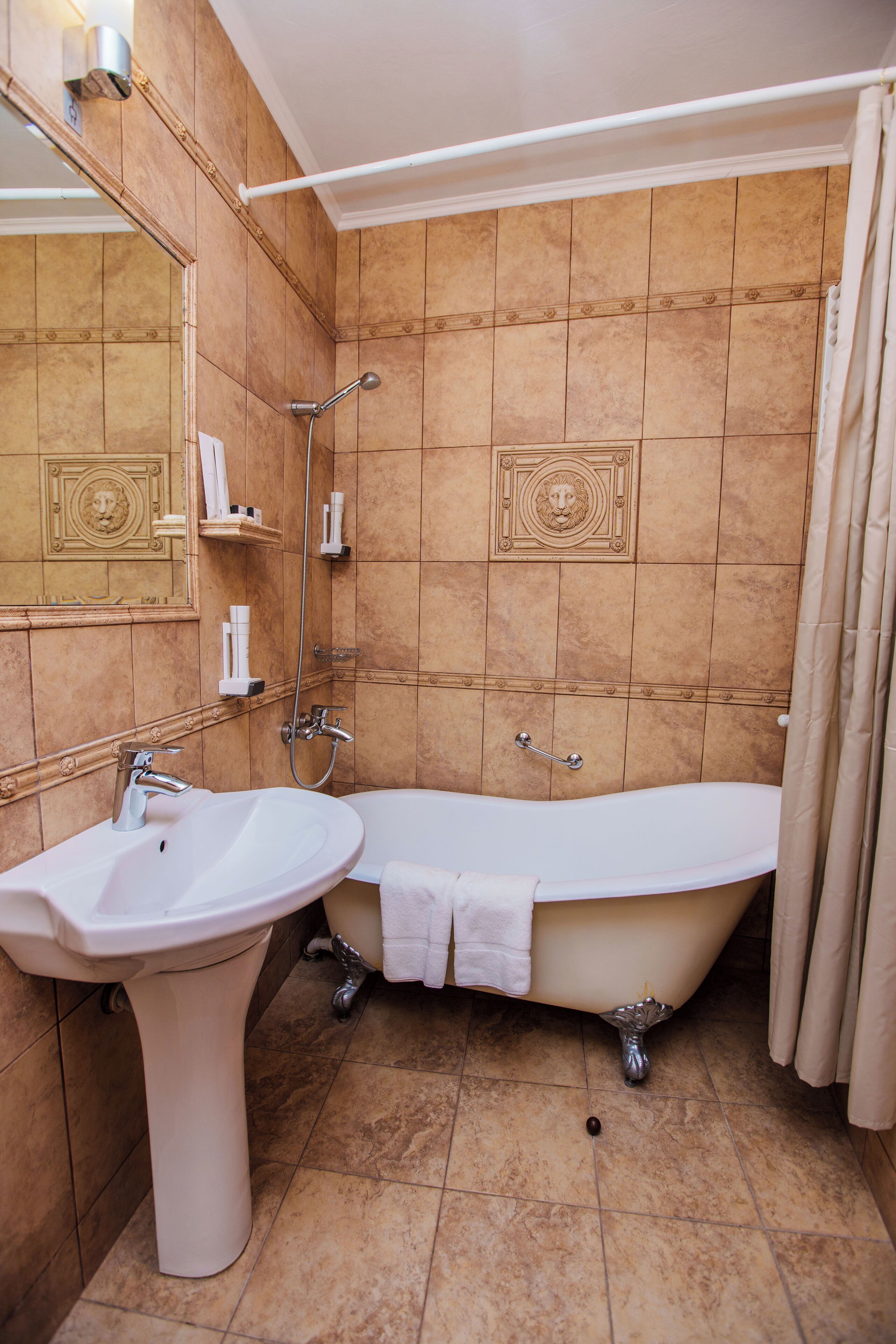 A bathroom with a sink, bathtub, and shower.