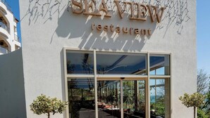The exterior of SEA VIEW restaurant with a clear view of the outdoor seating area through large glass doors. - Aqua View Spa Boutique Hotel (Varna)