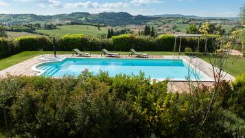 Seasonal outdoor pool, open 8:00 AM to 6:00 PM, pool umbrellas