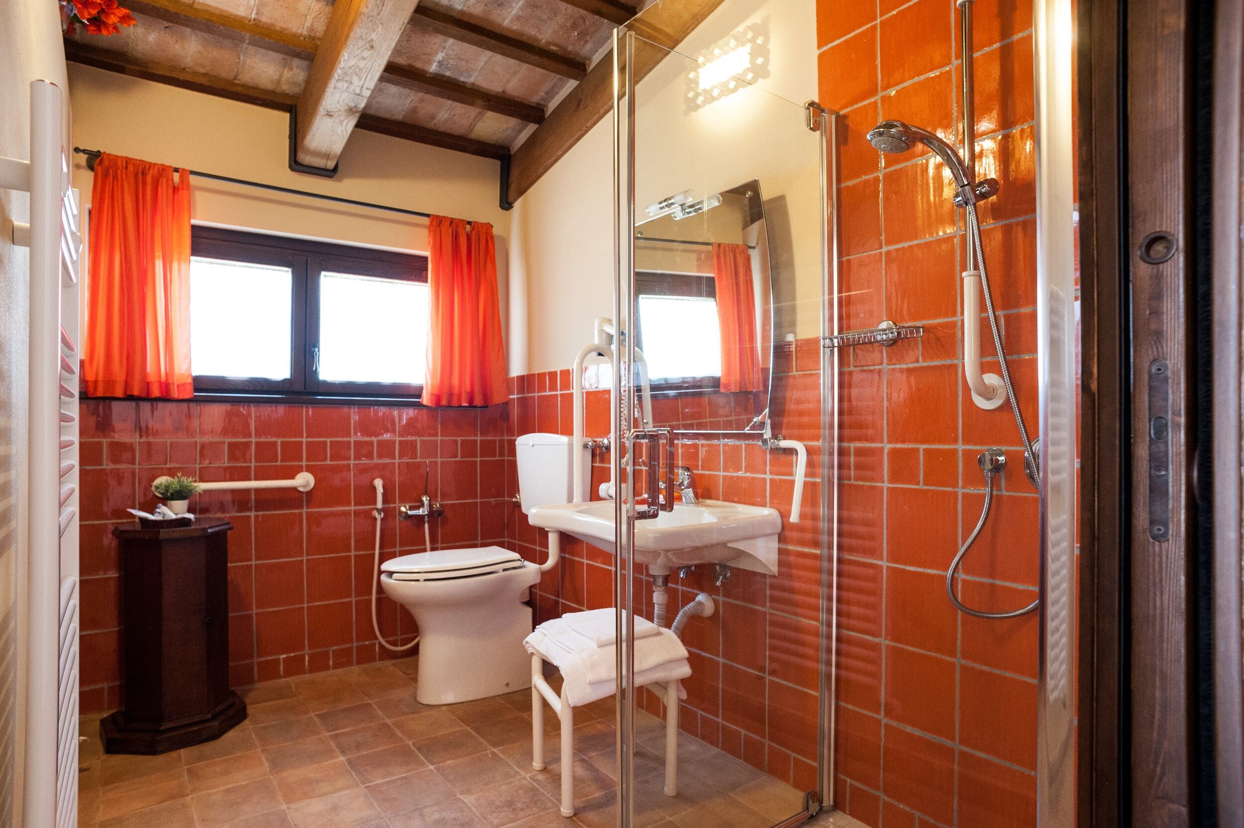 A bathroom with a toilet, sink, and shower.