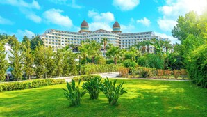 A large hotel with two prominent domes, surrounded by lush greenery and palm trees. - Sidemarin Kirman Premium - Ultra All Inclusive (Manavgat)
