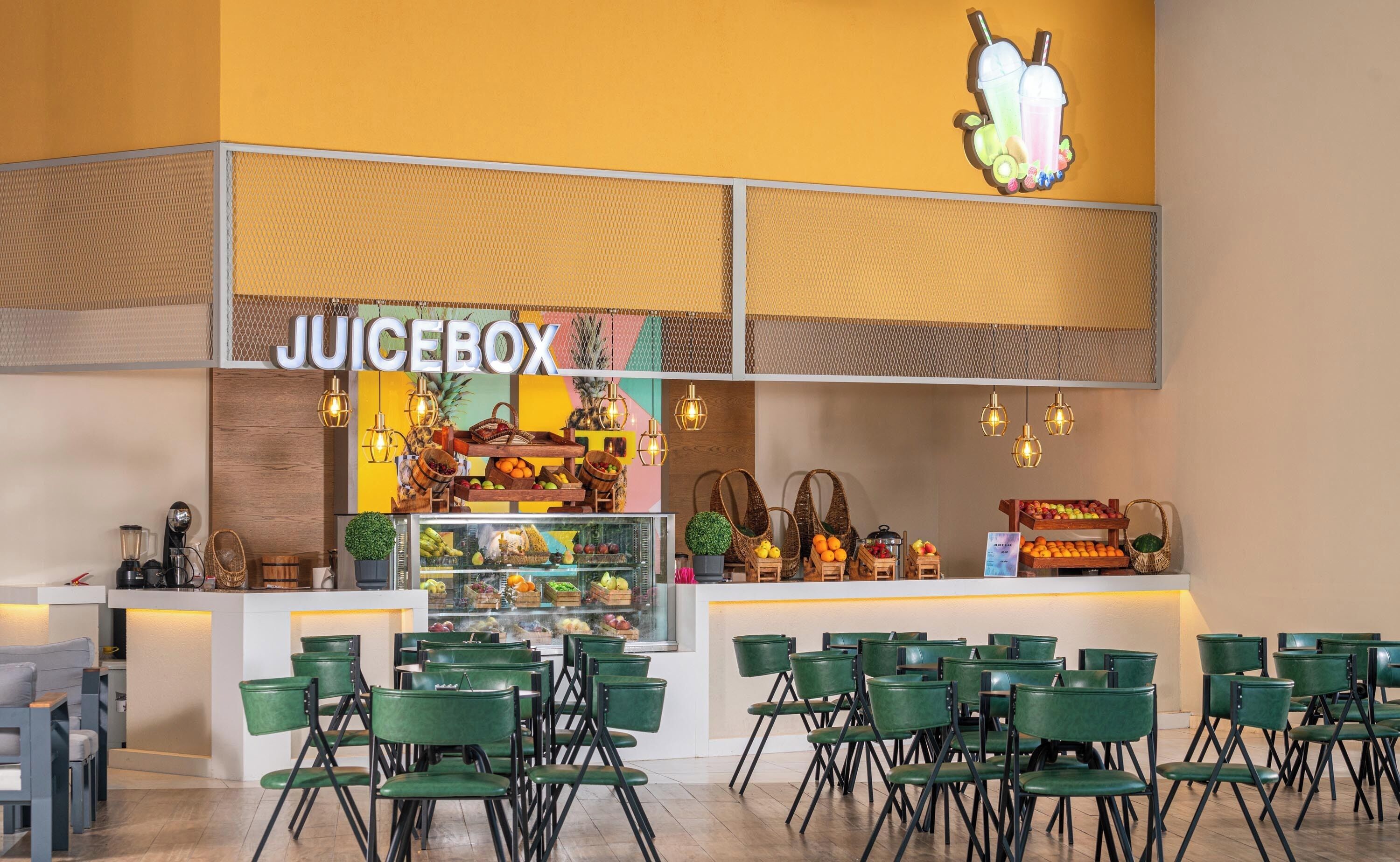 A juice bar named JUICEBOX with a variety of fruits and drinks displayed.