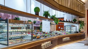 A buffet area with various food items and a glass display case. - Sidemarin Kirman Premium - Ultra All Inclusive (Manavgat)