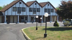 A two-story motel with a symmetrical facade, multiple windows, and a parking lot in front. - Lamplighter Motel - Clinton, Connecticut (Clinton)