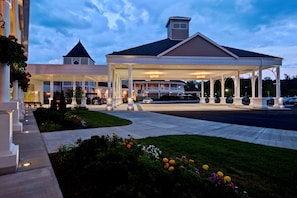 Hotel features a covered parking area and a beautifully landscaped garden with a large pavilion.