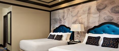 A hotel room with two beds, a nightstand with a lamp, and a large wall mural.