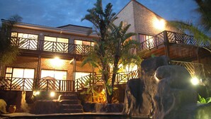A two-story building with a brick facade, large windows, and a balcony with a wooden railing. - Bon a Vie B and B and Self Catering (East London)