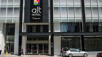 A modern hotel building with a prominent sign for 'Alt Hotel by Le Germain'.