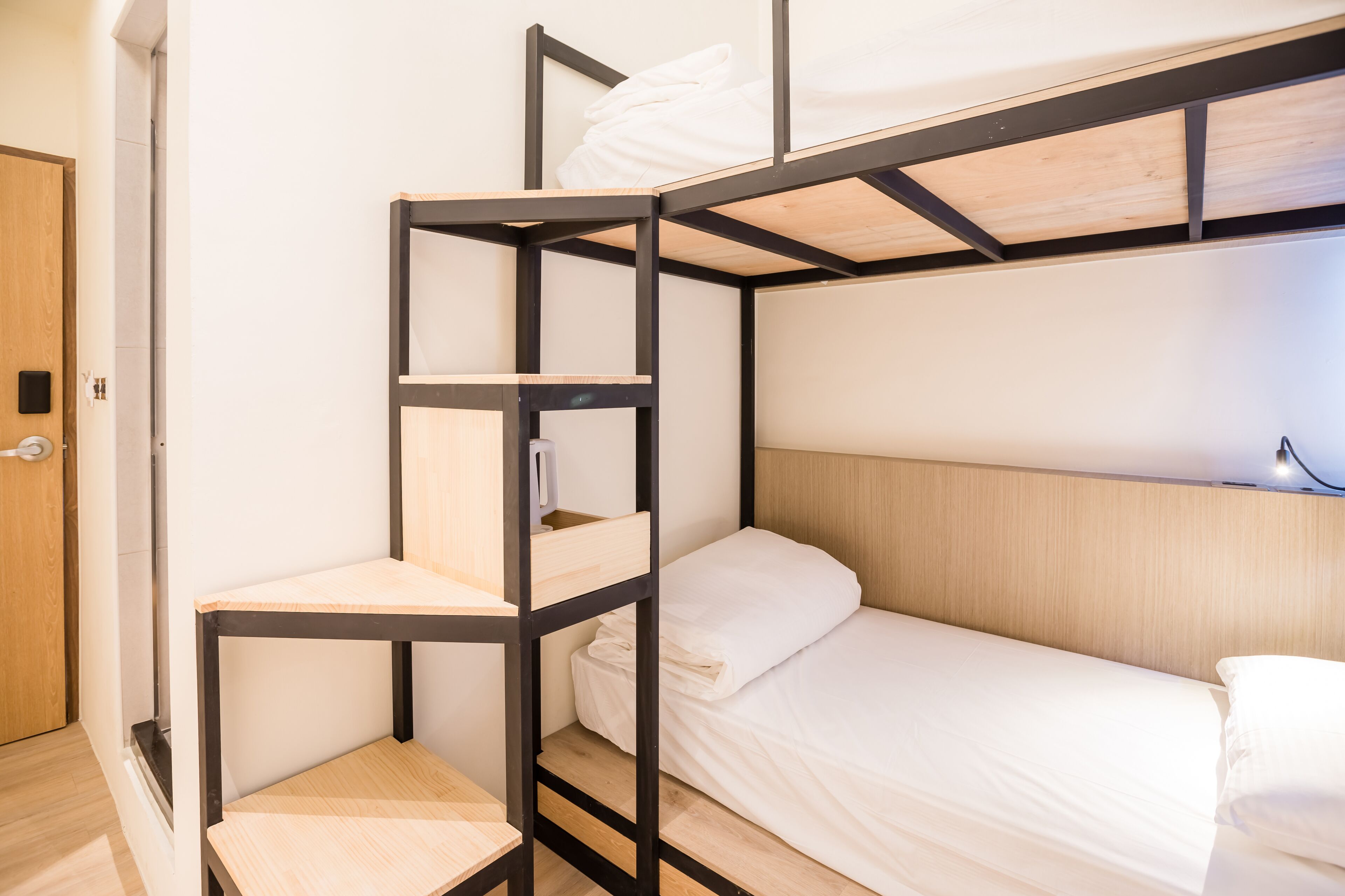 A bunk bed with a wooden headboard and a lower shelf.